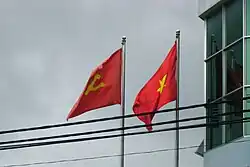 The national flag beside the flag of the Communist Party of Vietnam