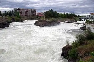 The Spokane River rushes past Snxw Meneɂ island in Riverfront Park