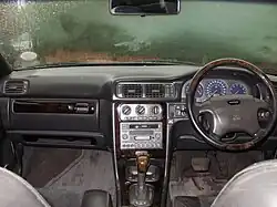 Interior view of the dashboard of an RHD V70 R with anthracite interior and walnut wood trim