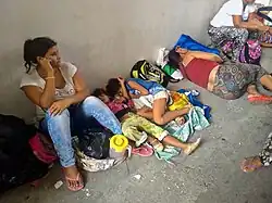 Women and children sleeping on the ground