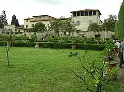 A decaying Tuscan villa stands against a clear-sky.