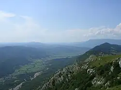 A photo showing a valley and a mountain