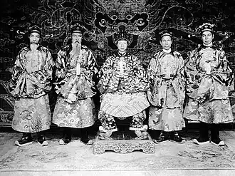 Emperor Khải Định (middle) and member of high ranking mandarins in court costume.