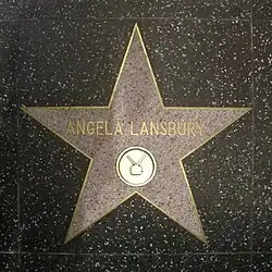A five-point star set in the ground; the name "Angela Lansbury" is written in the centre of it in gold lettering