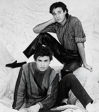 A black-and-white photograph of the members of the English pop duo Wham!, circa 1985.