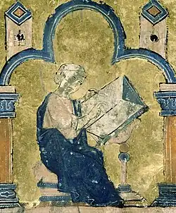 A miniature painting from a medieval manuscript, showing a man sitting at a desk writing a book.