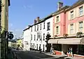 Street scene with white and pink buildings.