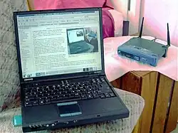 Black laptop with the router in the background