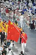 Yao Ming holding the Chinese flag during the 2008 Summer Olympics Parade of Nations.