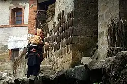 Buffalo dung drying on a house in Yunnan, China