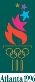A fire, emitting many different-colored stars, burns from a cauldron represented by the gold-colored Olympic rings and the number "100" acting as the cauldron's stand. The words "Atlanta 1996", also written in gold, are placed underneath. The image is situated on a dark green background, with a gold border.