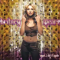 Spears brushing hair back with her hands