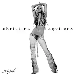 A black-and-white photo of Aguilera holding both hands over her head