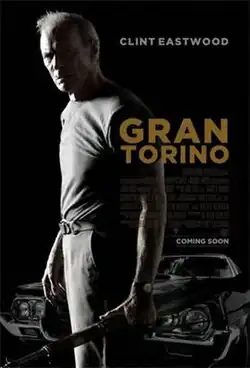 Clint Eastwood (in-character as Walt Kowalski) with his M1 Garand as he stands in front of his Ford Torino.
