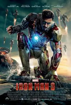 Tony Stark, as Iron Man in his battle damaged suit sitting with water around him, while his house behind is destroyed. Stark's Iron Legion is flying, while the Marvel logo with the film's title, credits and release date are below.