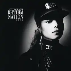 A young woman photographed in black and white wears an all-black, military-style uniform accented by silver-plated accessories. A spotlight shines on her face. To her left reads the text "Janet Jackson's Rhythm Nation 1814".