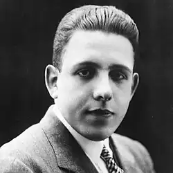 Monochrome photograph of a French man in a suit