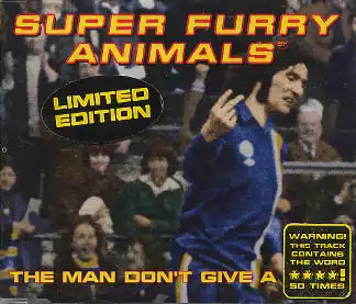 A dark-haired man in blue, white and yellow football kit scowls as he turns to his left, holding the index and middle fingers up on his right hand, his palm facing inwards. The hand points to an out-of-image figure, but appears to be pointing to the viewer. "Super Furry Animals" is rendered in yellow and red text across the top, while along the bottom the single's title is partially given: "The Man Don't Give a ****". The final word is obscured by a sticker, which itself claims that the word is used 50 times during the song
